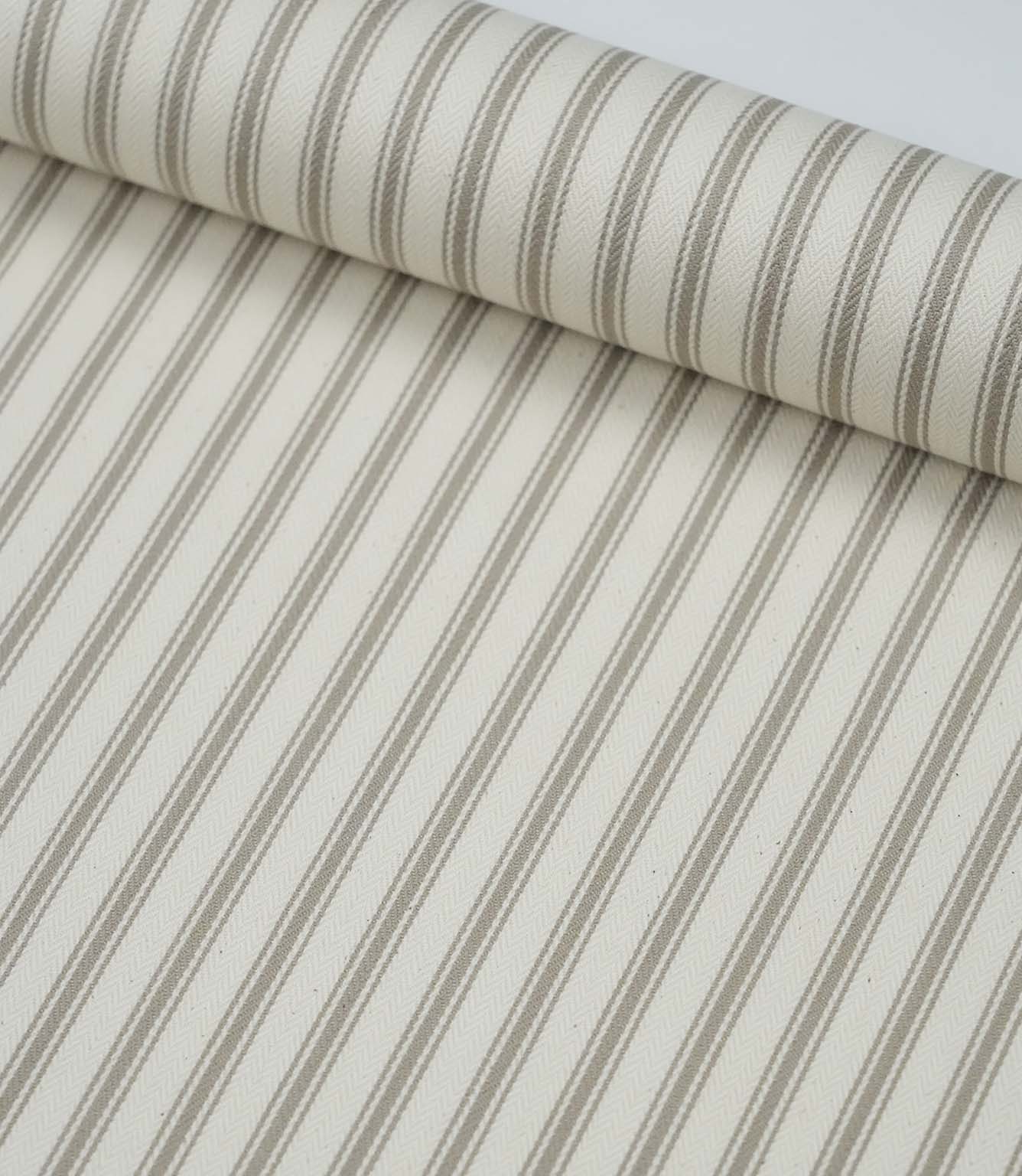 Rolled beige ticking stripe fabric highlighting the elegant neutral stripes and soft woven finish.