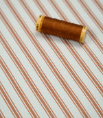 Burnt orange ticking stripe fabric with matching burnt orange thread, ideal for upholstery, curtains, blinds and sewing projects.