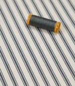 Grey ticking stripe fabric with matching grey thread, ideal for upholstery, curtains, blinds and sewing projects.