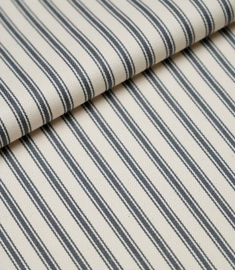Folded grey ticking stripe fabric showcasing the timeless striped pattern and premium woven finish.