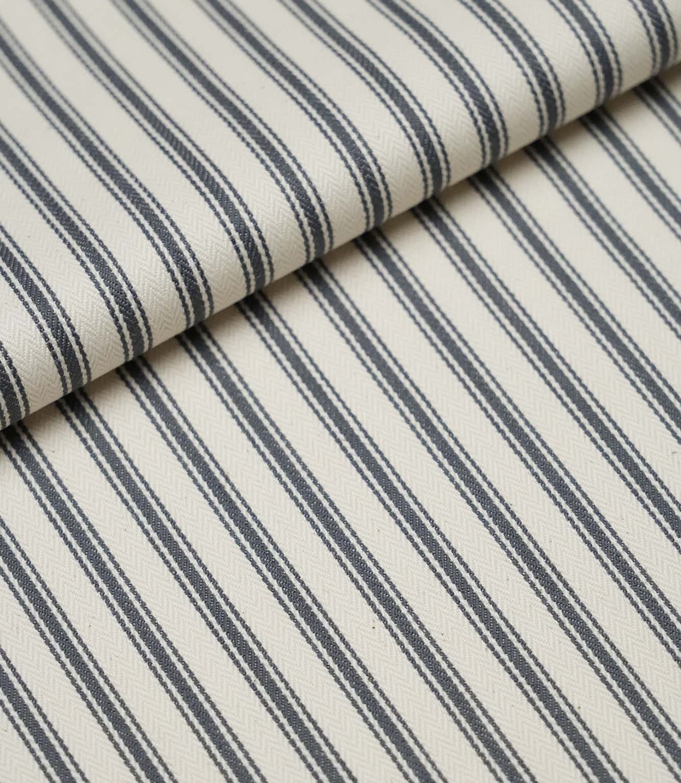Folded grey ticking stripe fabric showcasing the timeless striped pattern and premium woven finish.