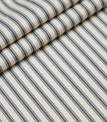 Layered folds of grey ticking stripe fabric displaying the fine herringbone weave and classic striped design.