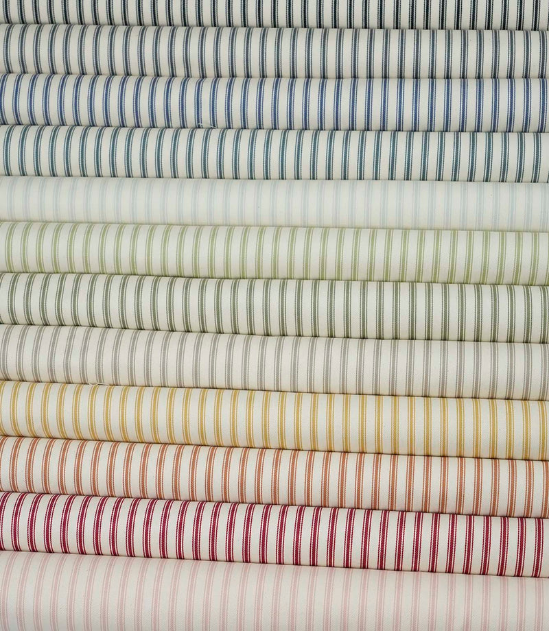 Ticking stripe fabric displayed alongside coordinating colourways from the Just Fabrics collection.