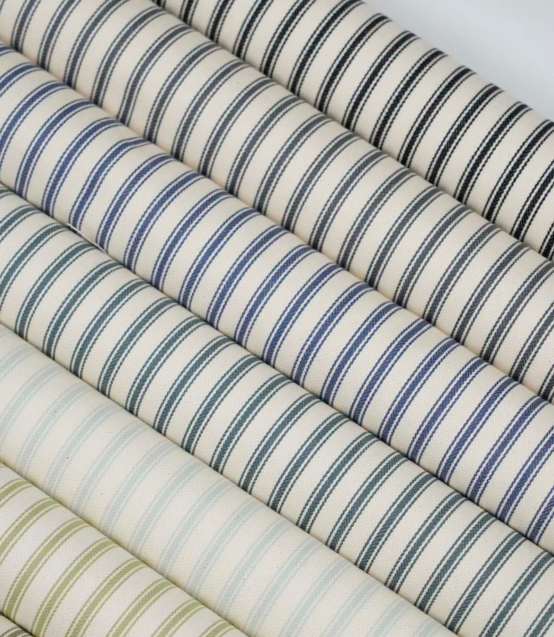 Collection of ticking stripe fabrics in a range of colours, featuring classic woven stripes on ivory backgrounds.