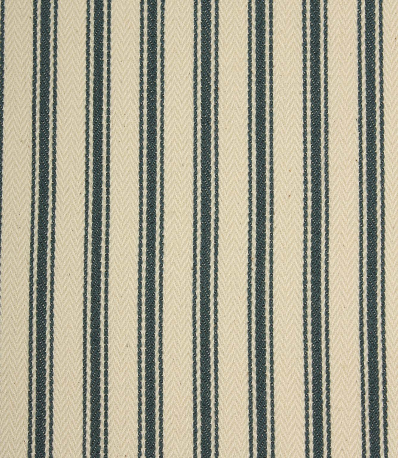 Close-up of indigo striped ticking fabric highlighting the textured woven finish, fine stripe detailing, and soft ivory base.