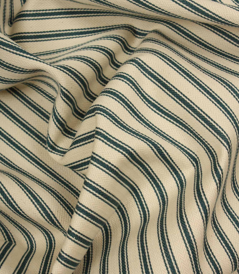 Draped ivory and indigo striped fabric with flowing folds, showing the durable woven texture and timeless upholstery-inspired design.
