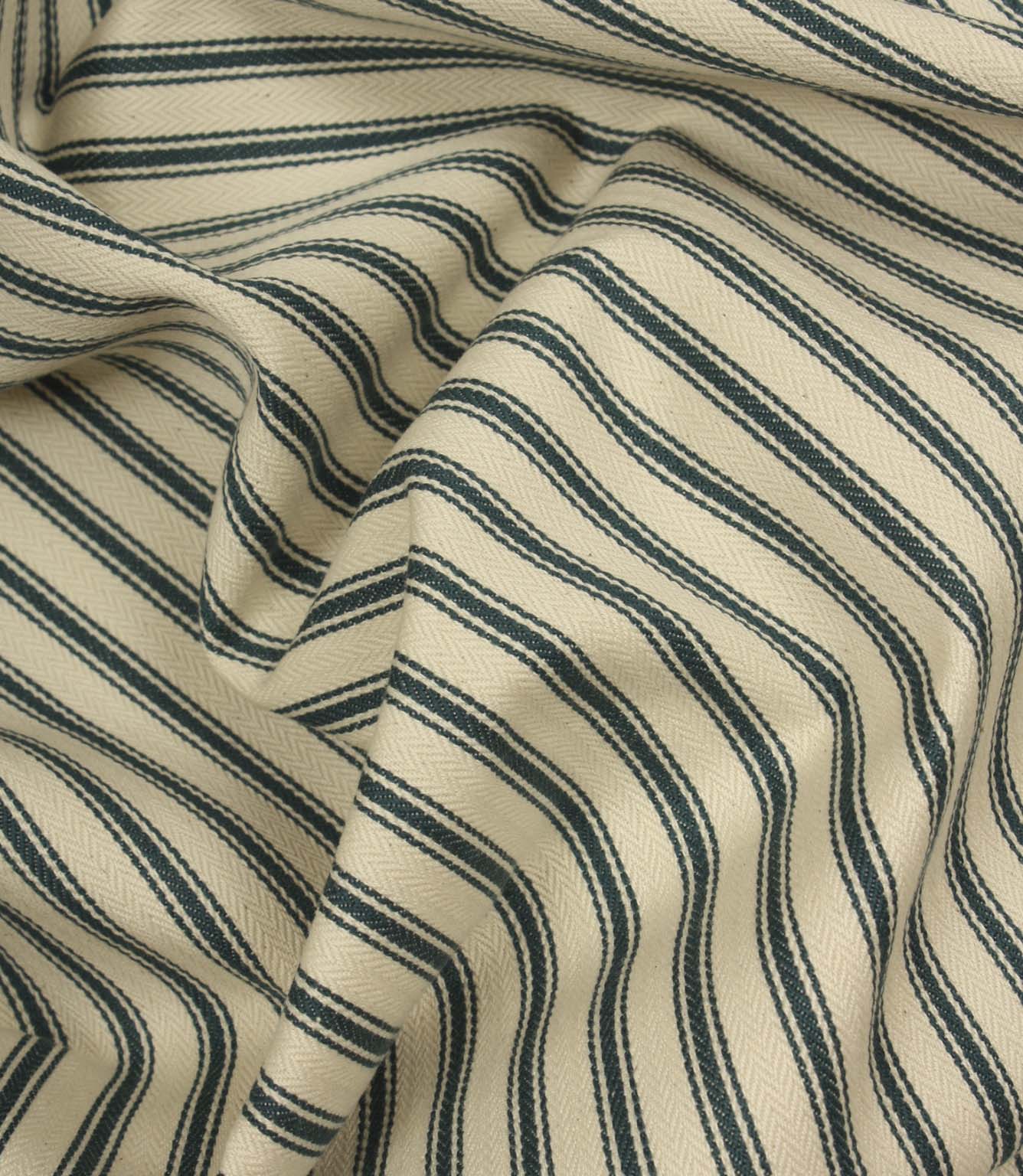 Draped ivory and indigo striped fabric with flowing folds, showing the durable woven texture and timeless upholstery-inspired design.