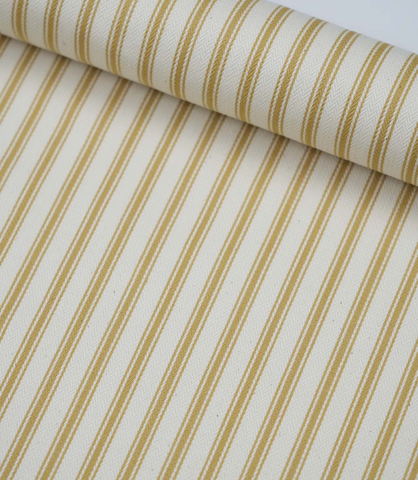 Rolled ochre ticking stripe fabric highlighting the classic striped design and subtle woven herringbone texture.