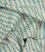 Gathered Pacific blue ticking stripe fabric showing natural folds and durable woven finish.