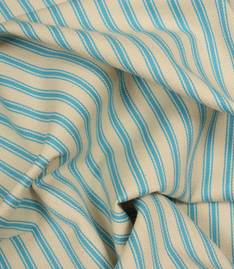 Gathered Pacific blue ticking stripe fabric showing natural folds and durable woven finish.