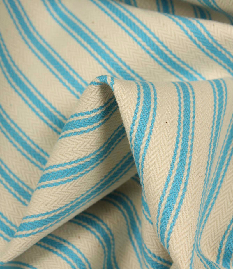 Detailed close-up of Pacific blue striped ticking fabric with visible herringbone weave and soft textured folds.