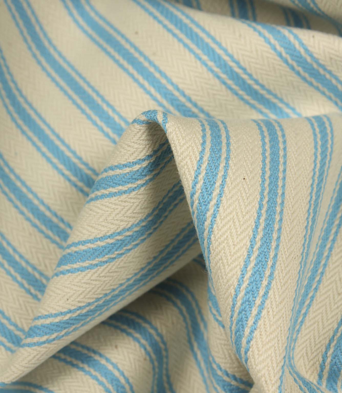 Detailed close-up of Pacific blue striped ticking fabric with visible herringbone weave and soft textured folds.