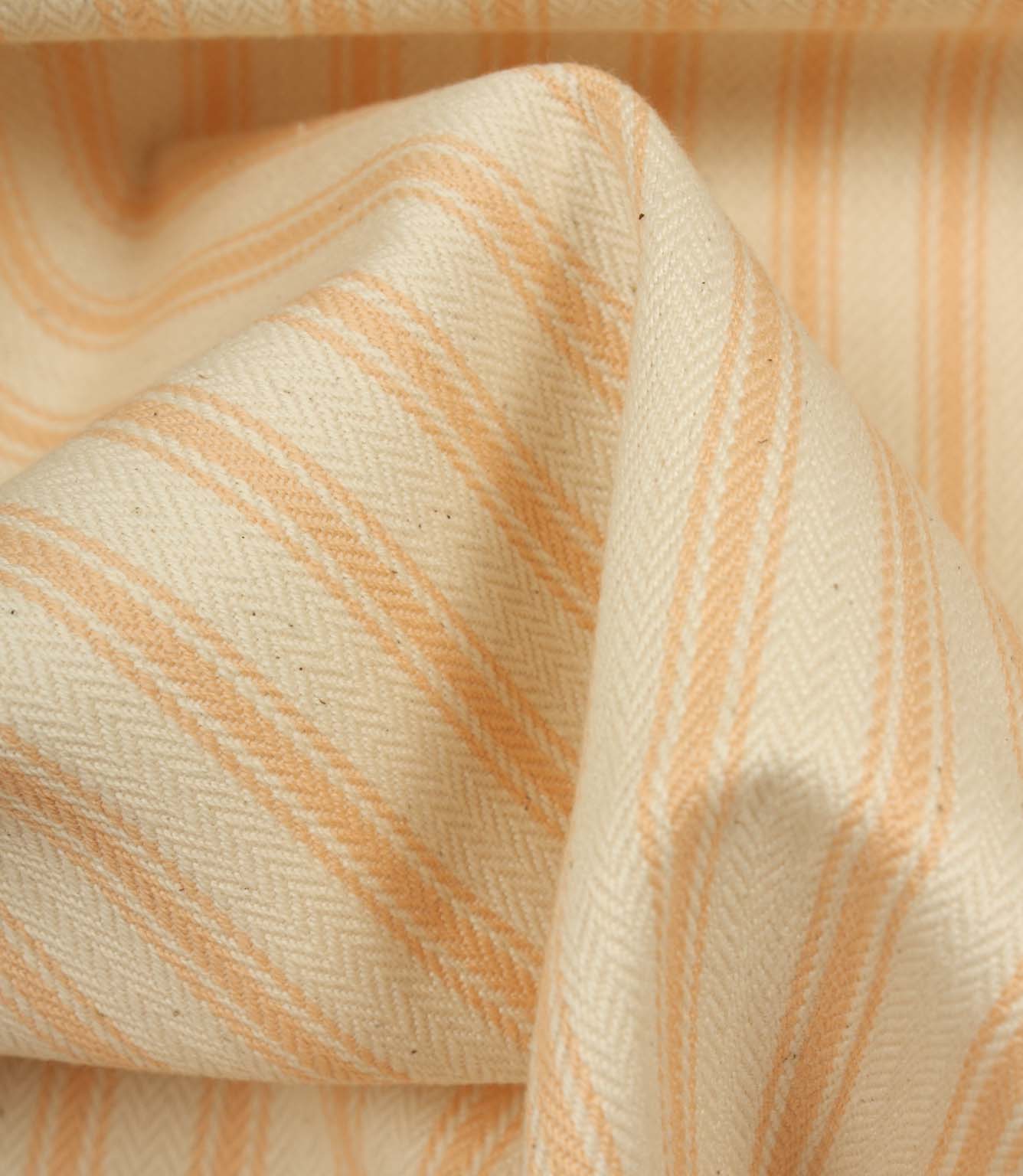 Detailed close-up of peach striped ticking fabric with visible herringbone weave and soft fabric drape.
