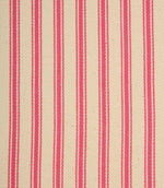 Close-up of ivory herringbone weave fabric featuring bold petunia pink ticking stripes and textured detailing.