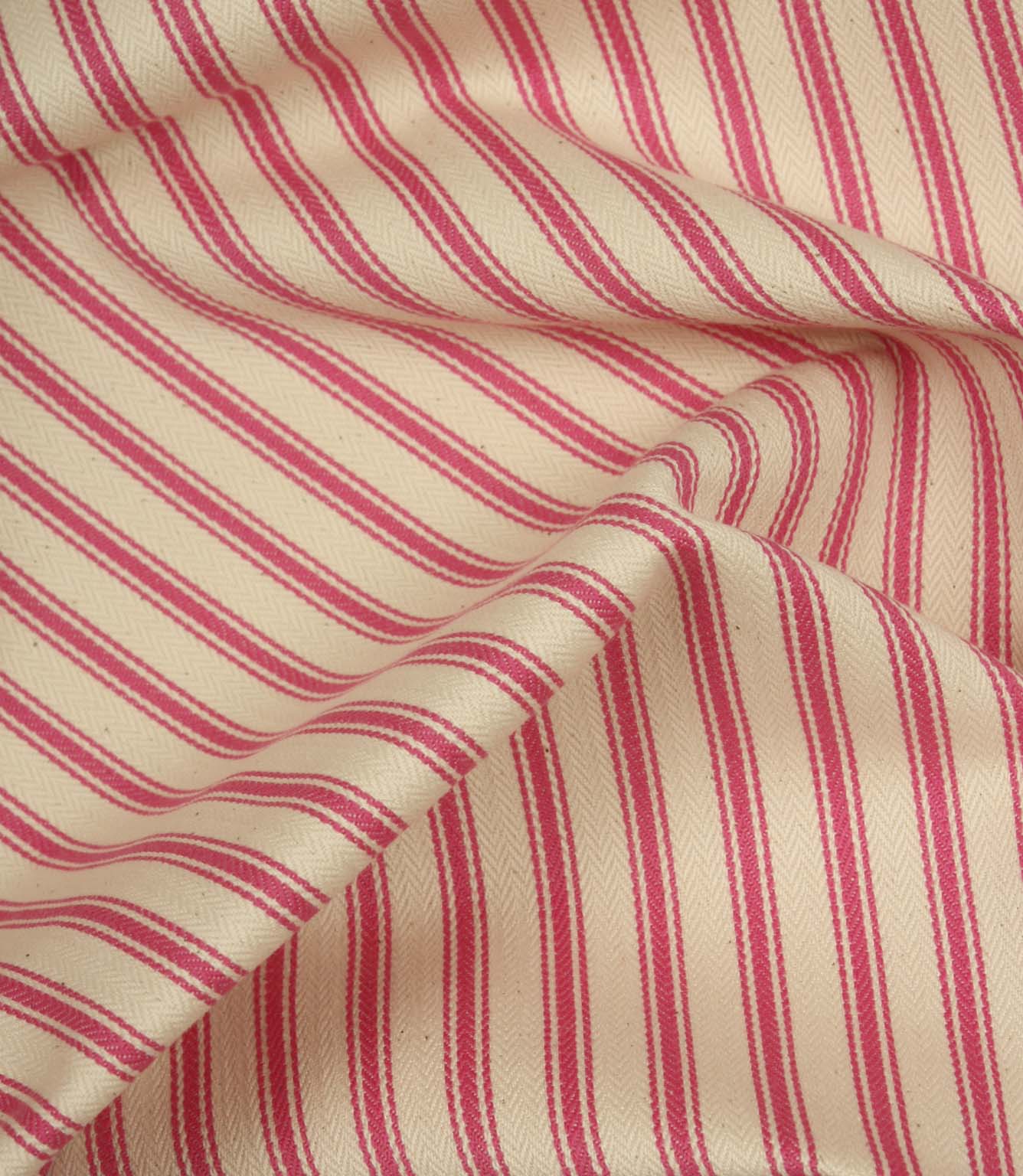 Draped petunia pink ticking stripe fabric highlighting flowing folds and the classic woven stripe pattern.
