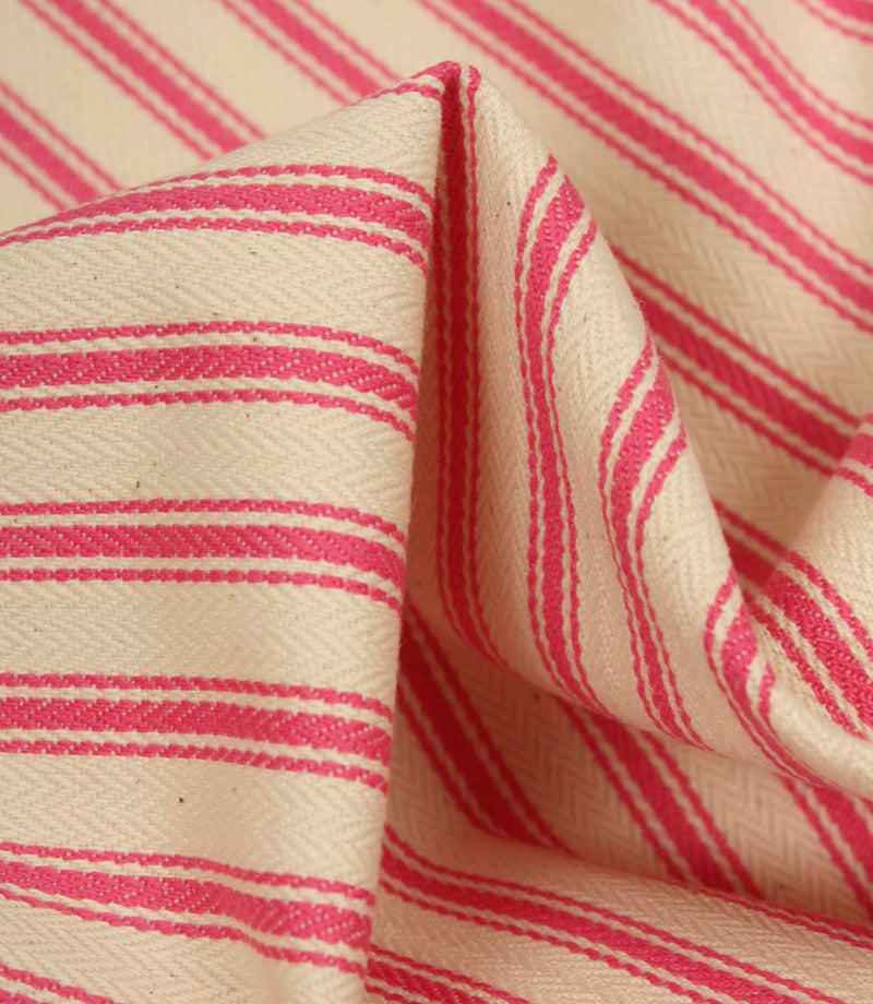 Detailed close-up of petunia pink striped ticking fabric with visible herringbone weave and soft fabric folds.