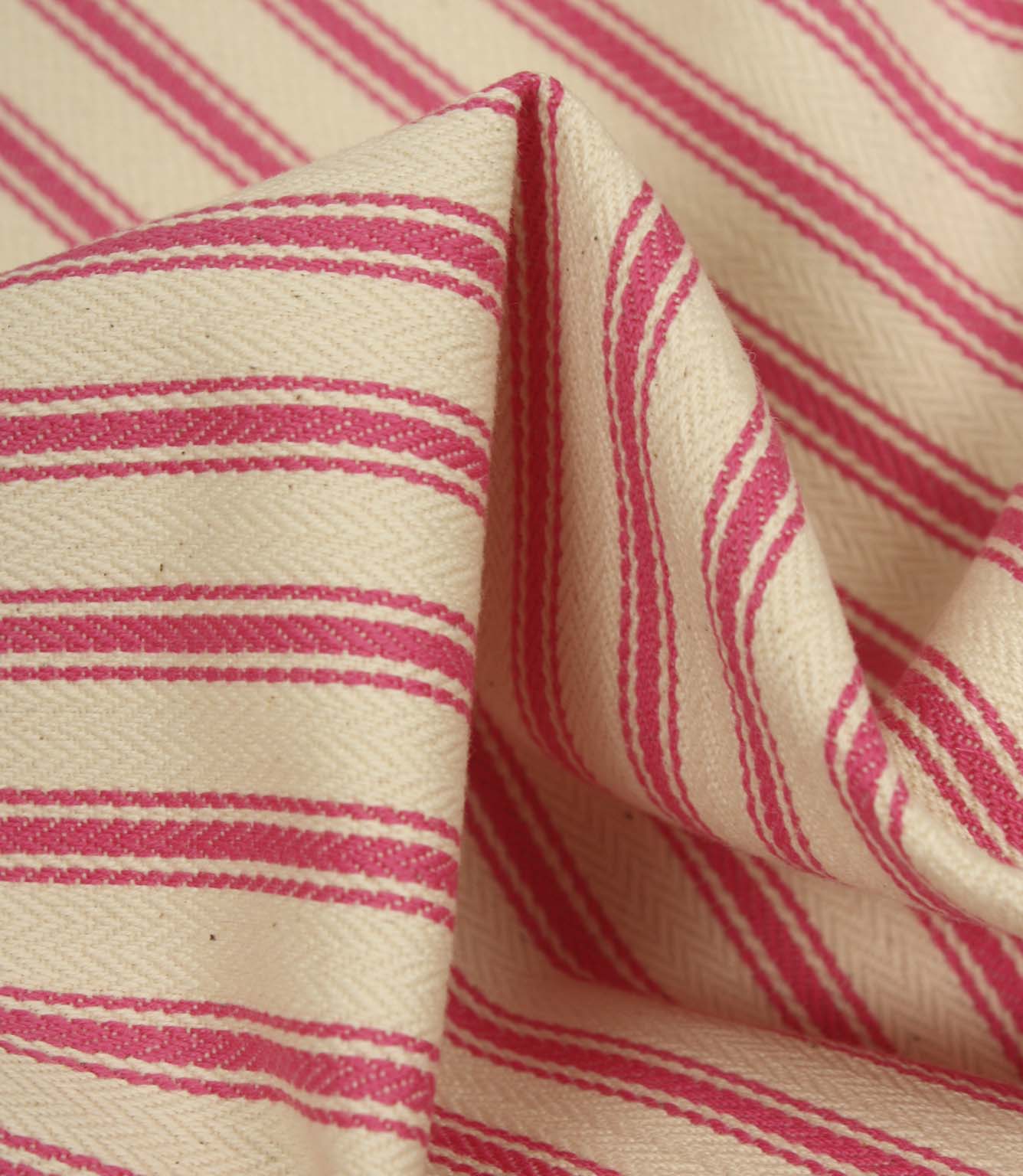 Detailed close-up of petunia pink striped ticking fabric with visible herringbone weave and soft fabric folds.