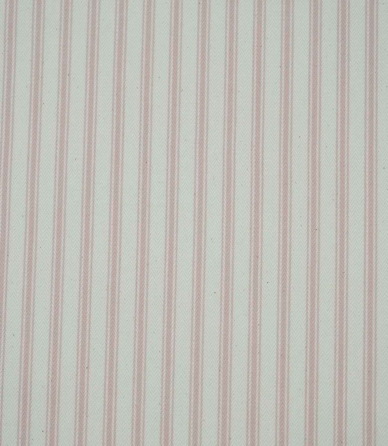 Close-up of pink ticking stripe fabric highlighting the classic striped design and woven herringbone texture.