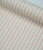 Rolled pink ticking stripe fabric highlighting the classic striped design and subtle woven herringbone texture.