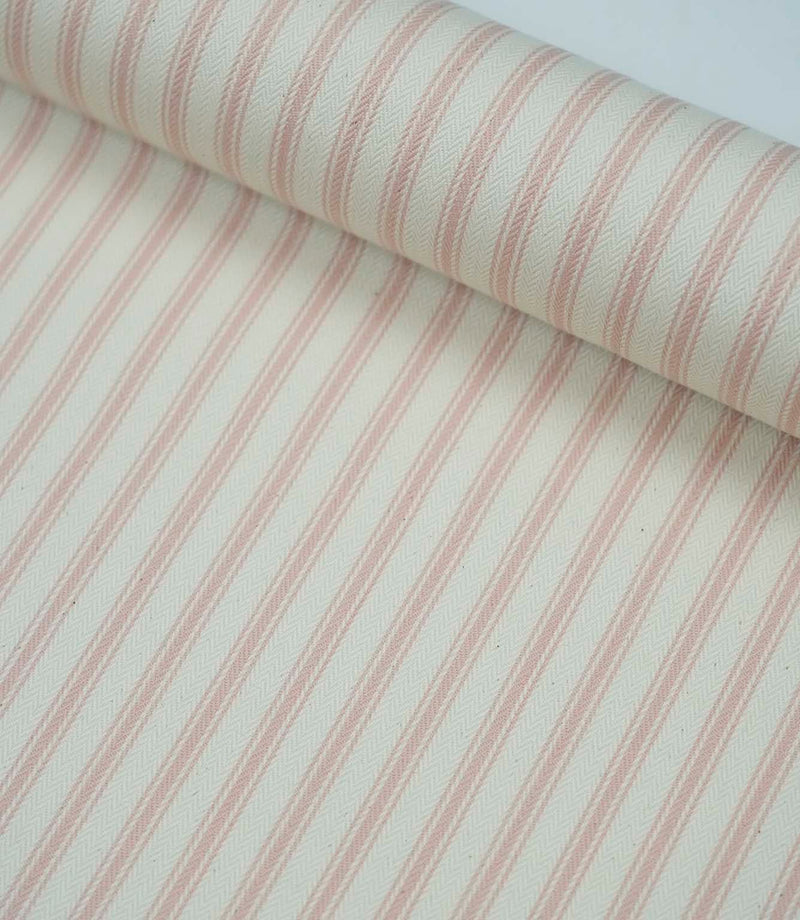 Rolled pink ticking stripe fabric highlighting the classic striped design and subtle woven herringbone texture.