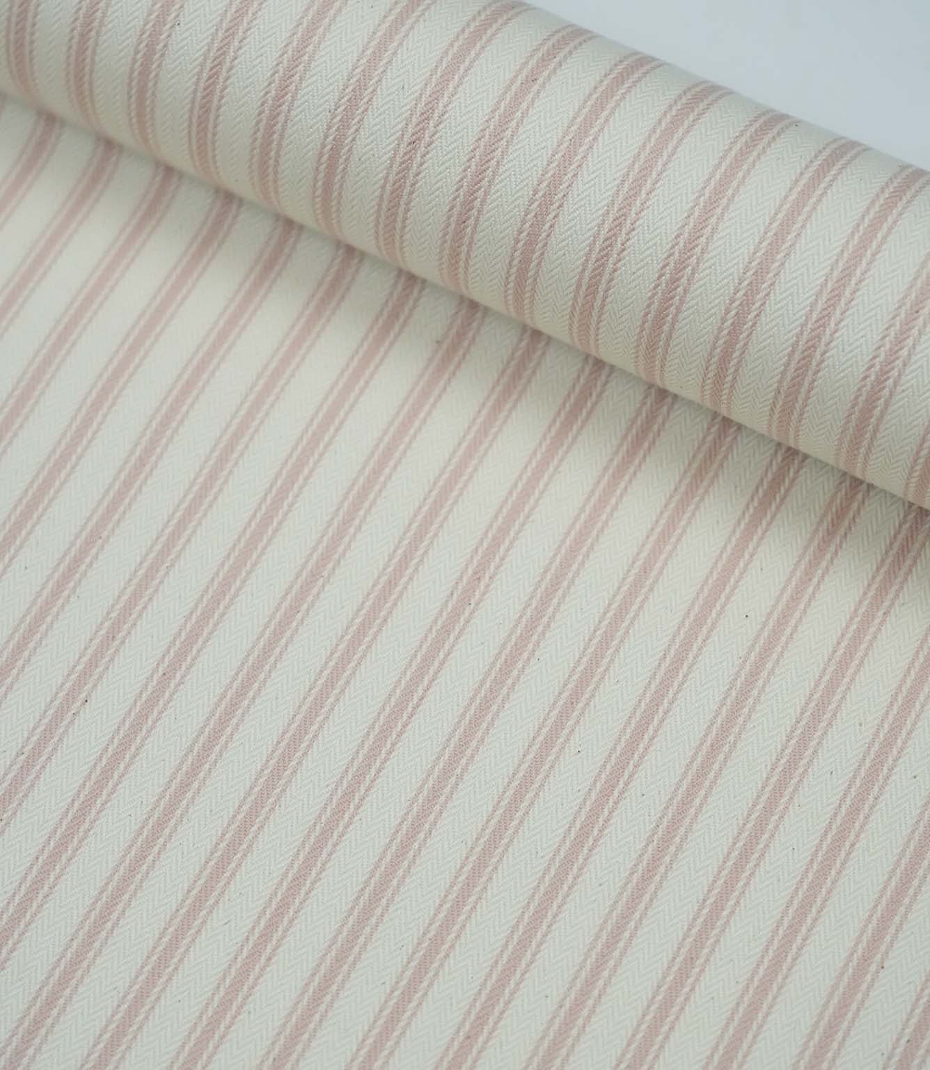 Rolled pink ticking stripe fabric highlighting the classic striped design and subtle woven herringbone texture.