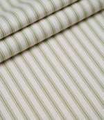 Layered folds of sage green ticking stripe fabric displaying the fine herringbone weave and classic striped design.