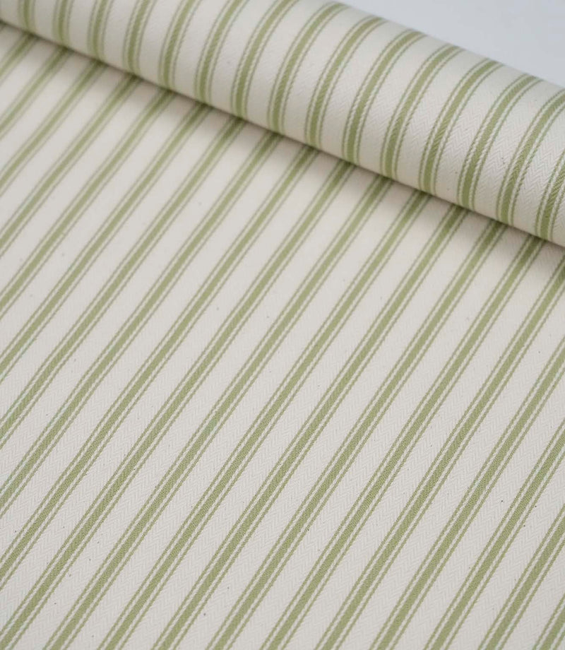 Rolled sage green ticking stripe fabric highlighting the classic striped design and subtle woven herringbone texture.