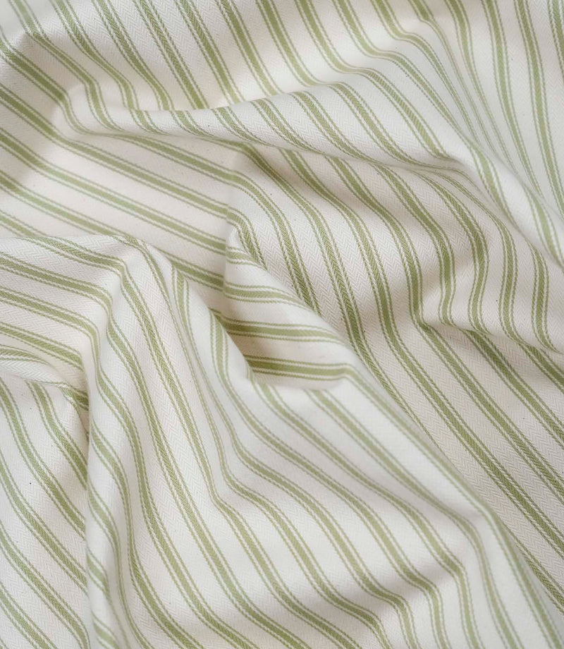 Sage green ticking stripe fabric draped to show its soft handle, elegant stripe pattern and woven herringbone texture.