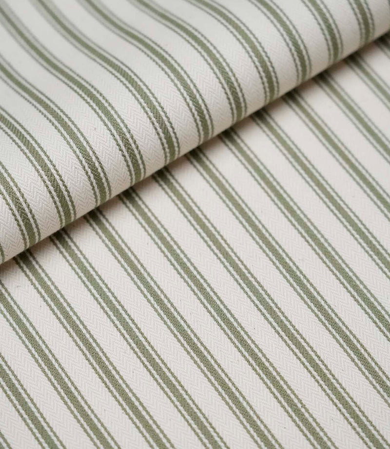 Folded sap green ticking stripe fabric showcasing the timeless striped pattern and premium woven herringbone finish.