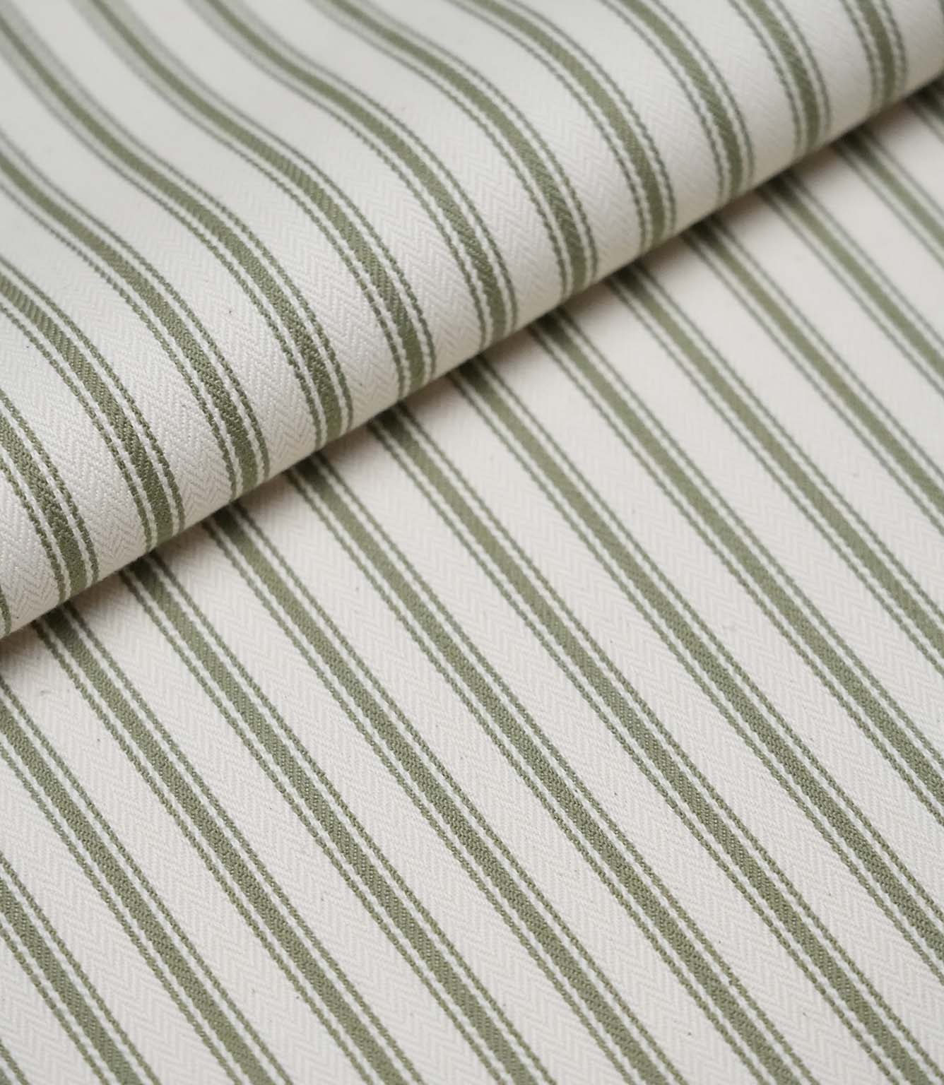 Folded sap green ticking stripe fabric showcasing the timeless striped pattern and premium woven herringbone finish.