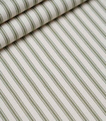 Layered folds of sap green ticking stripe fabric displaying the fine herringbone weave and classic striped design.