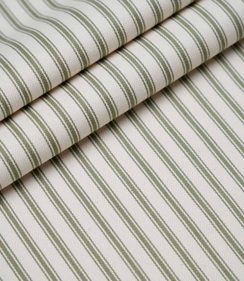 Rolled sap green ticking stripe fabric highlighting the classic striped design and subtle woven herringbone texture.