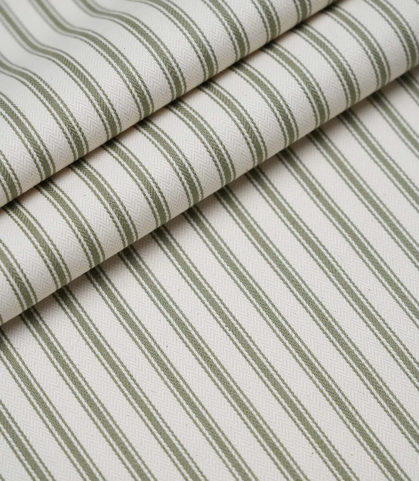 Rolled sap green ticking stripe fabric highlighting the classic striped design and subtle woven herringbone texture.
