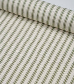 Sap green ticking stripe fabric draped to show its soft handle, elegant stripe pattern and woven herringbone texture.