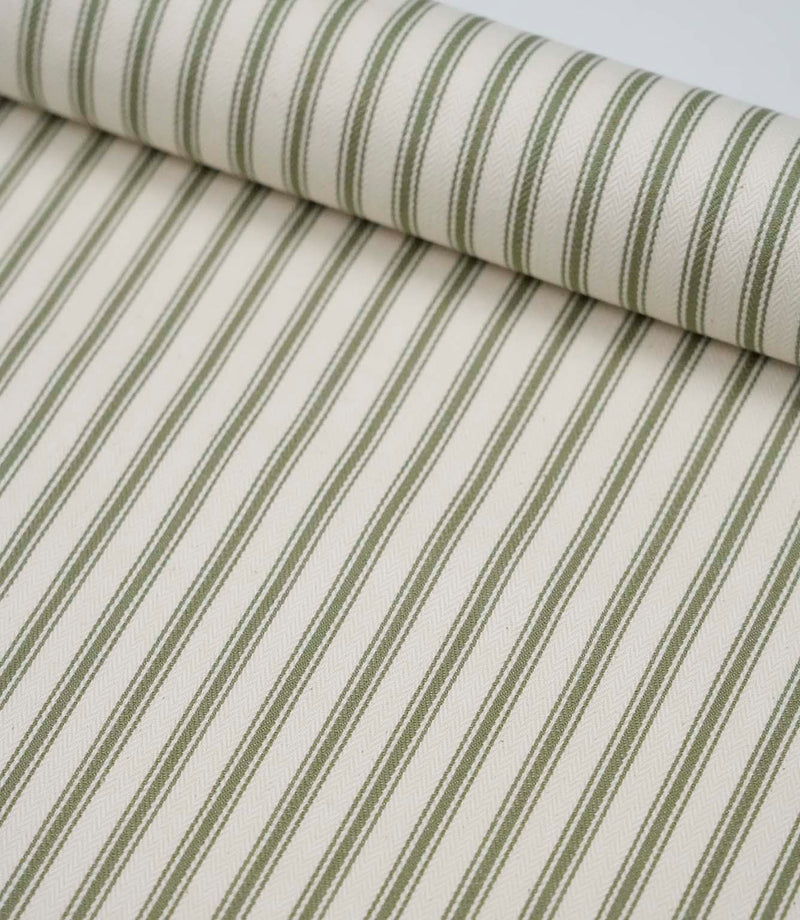 Sap green ticking stripe fabric draped to show its soft handle, elegant stripe pattern and woven herringbone texture.