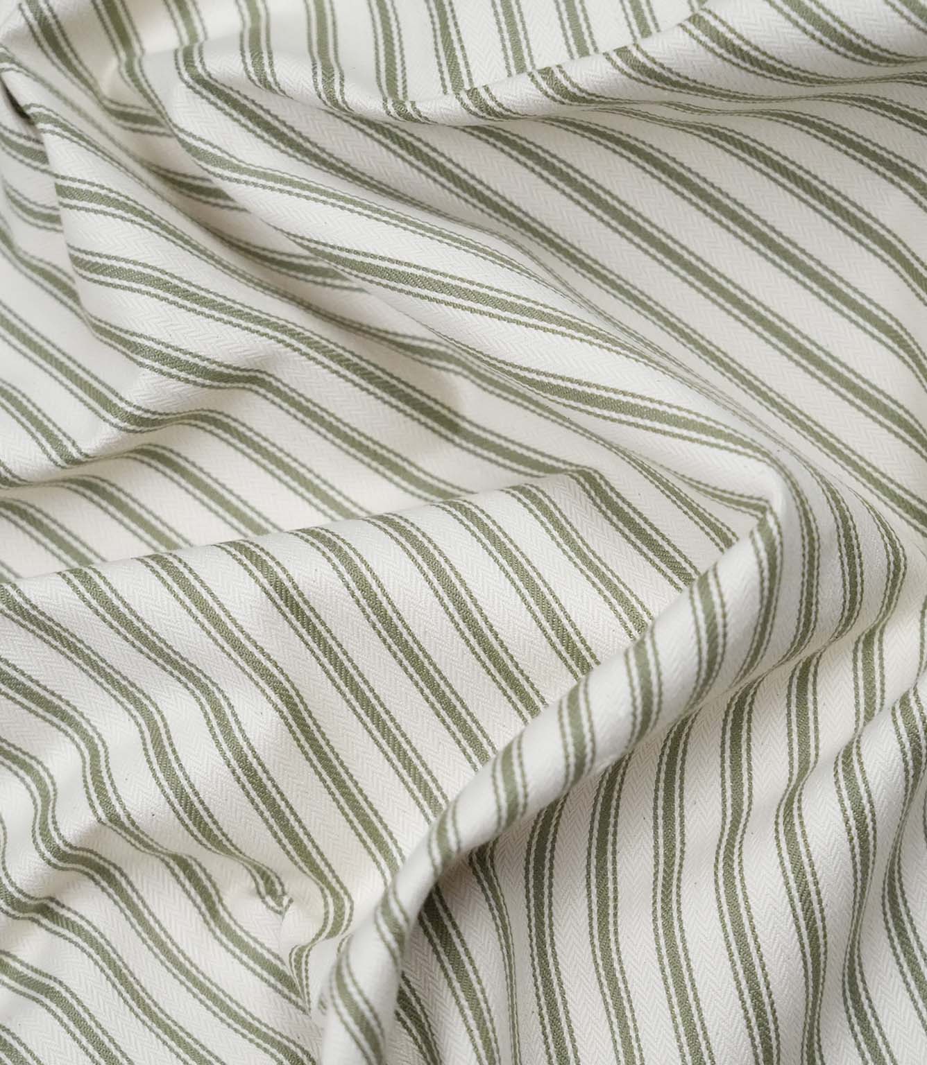 Close-up detail of sap green ticking stripe fabric showing the fine woven herringbone texture and classic green ticking stripes.