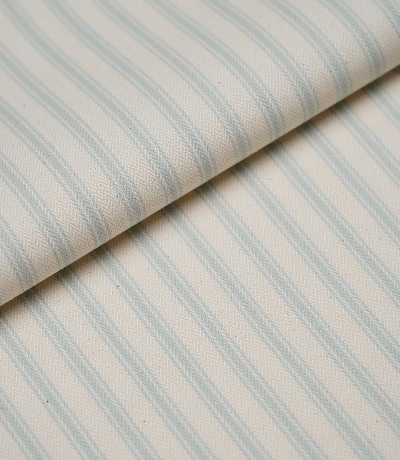 Folded Sea Spray ticking stripe fabric highlighting the soft drape, woven texture and classic striped design.