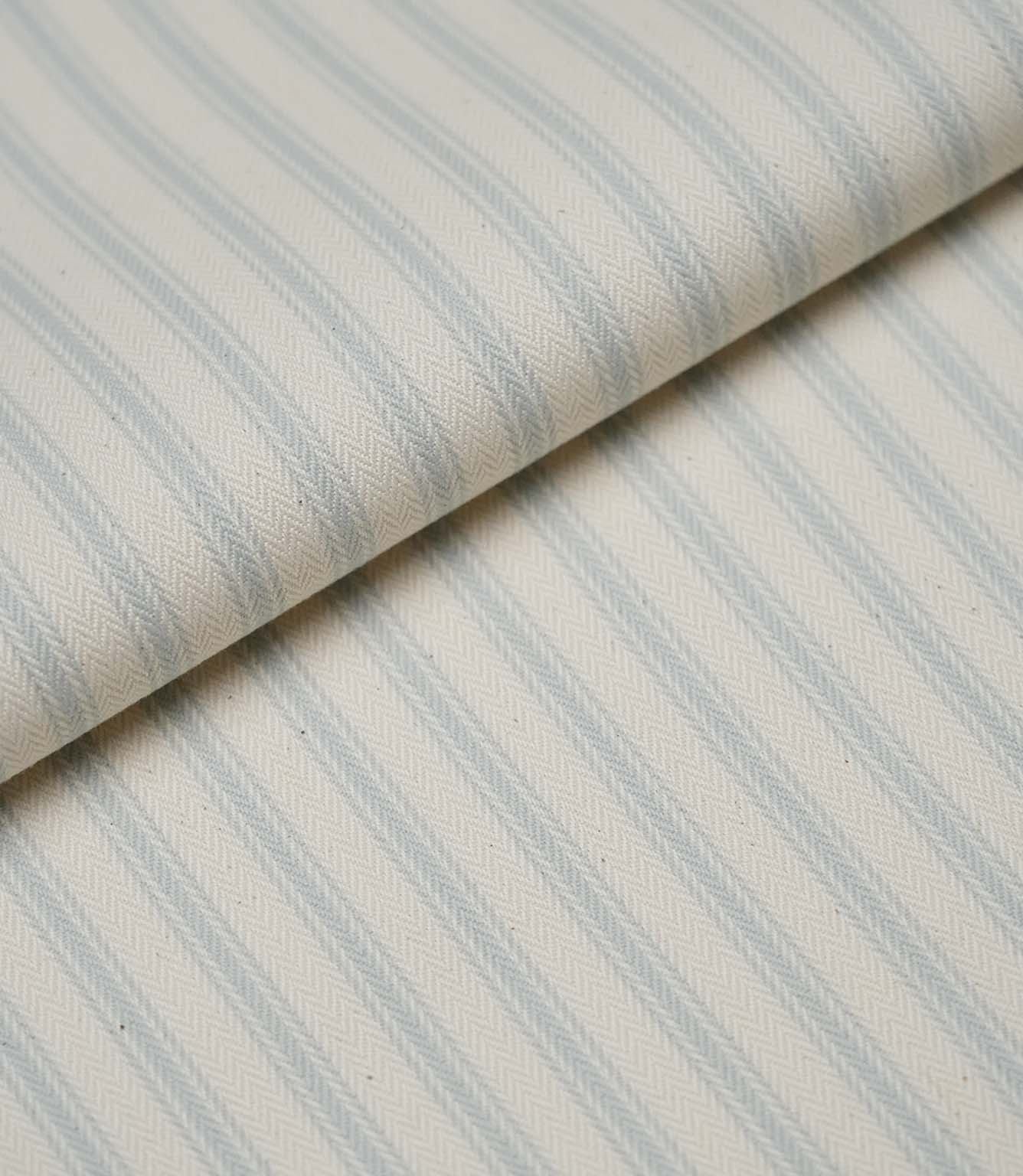 Folded Sea Spray ticking stripe fabric highlighting the soft drape, woven texture and classic striped design.