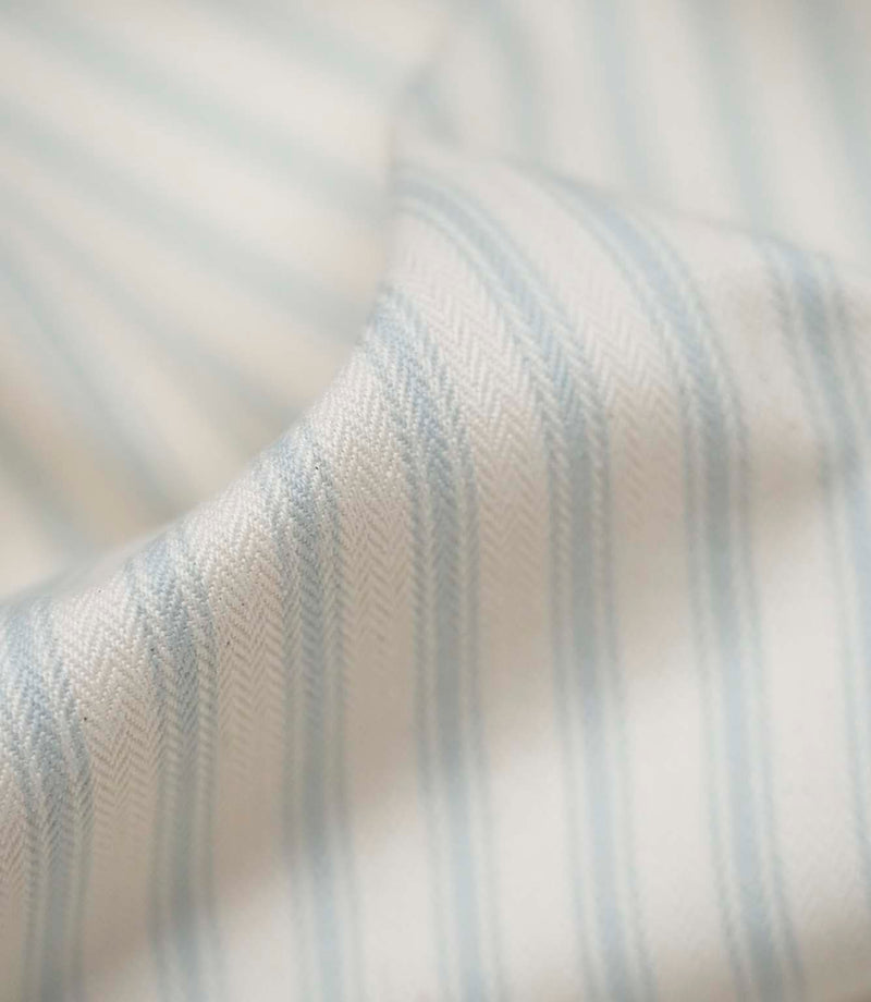 Close-up of Sea Spray ticking stripe fabric highlighting the woven texture, soft finish and delicate blue stripes.