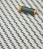 Teal ticking stripe fabric with matching teal thread, ideal for upholstery, curtains, blinds and sewing projects.