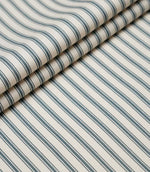 Layered folds of teal ticking stripe fabric displaying the fine herringbone weave and classic striped design.