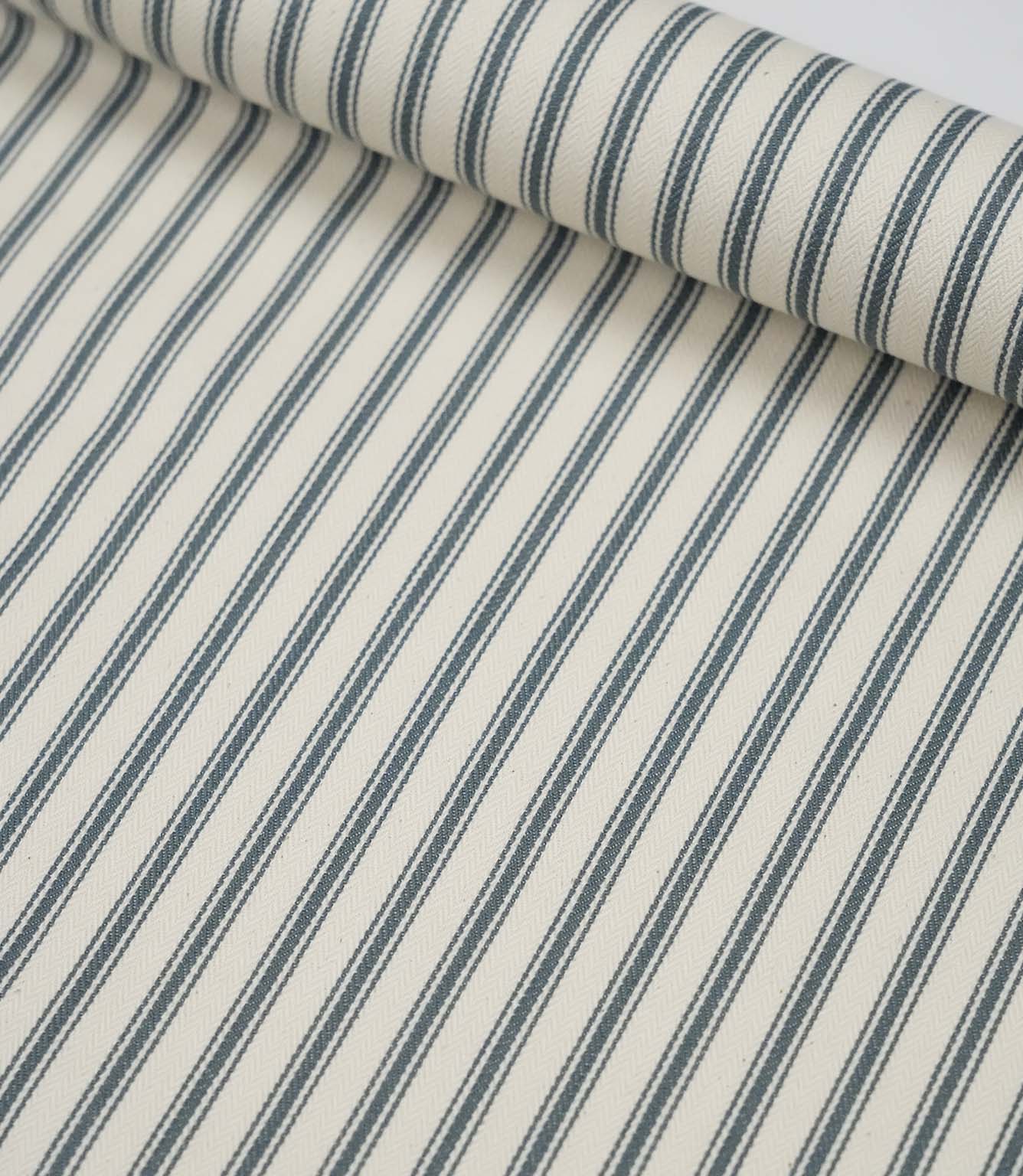 Rolled teal ticking stripe fabric highlighting the classic striped design and subtle woven herringbone texture.