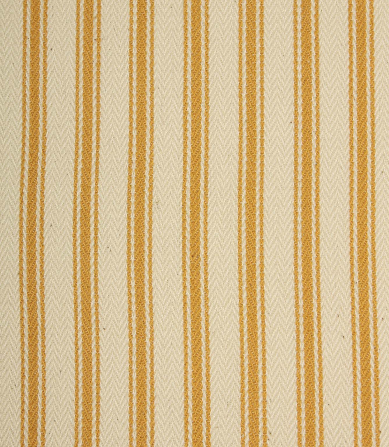 Close-up of ivory herringbone weave fabric featuring fine turmeric yellow ticking stripes and textured detailing.