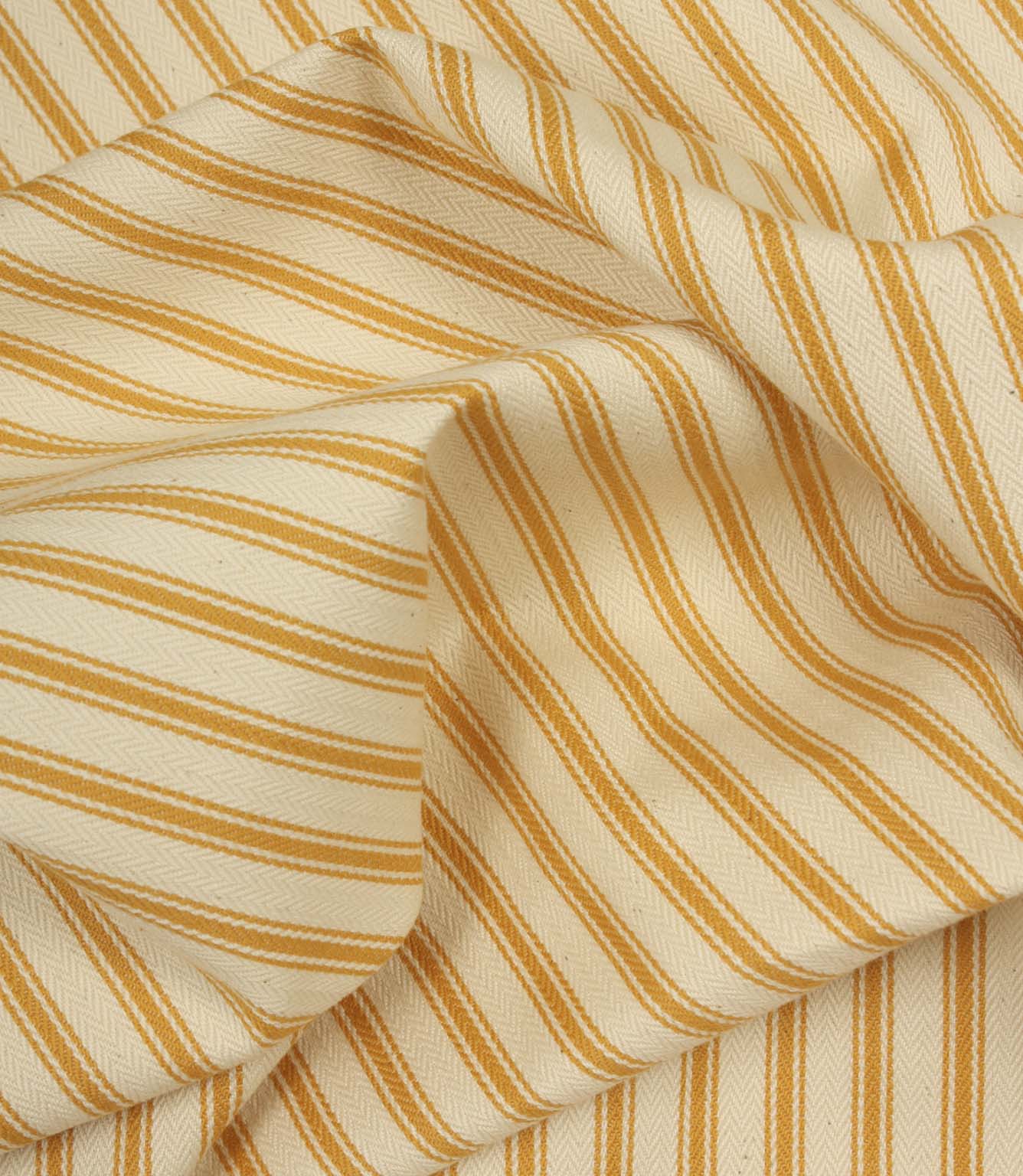 Gathered turmeric yellow ticking stripe fabric showing natural folds and durable woven finish.