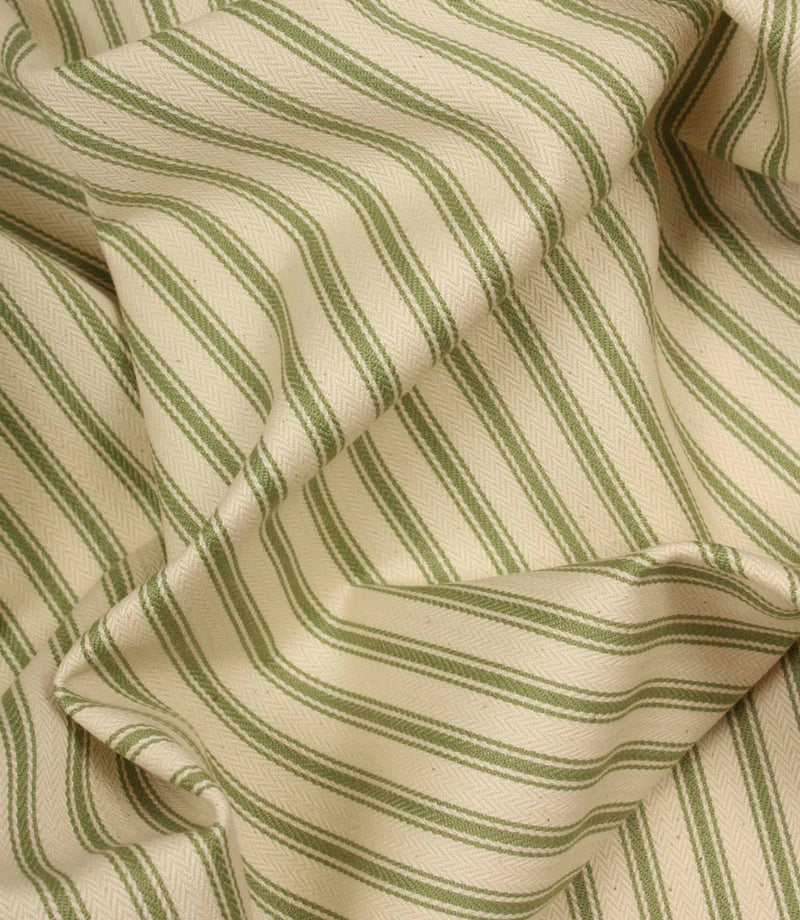 Draped warm green ticking stripe fabric highlighting soft folds and the timeless woven stripe pattern.