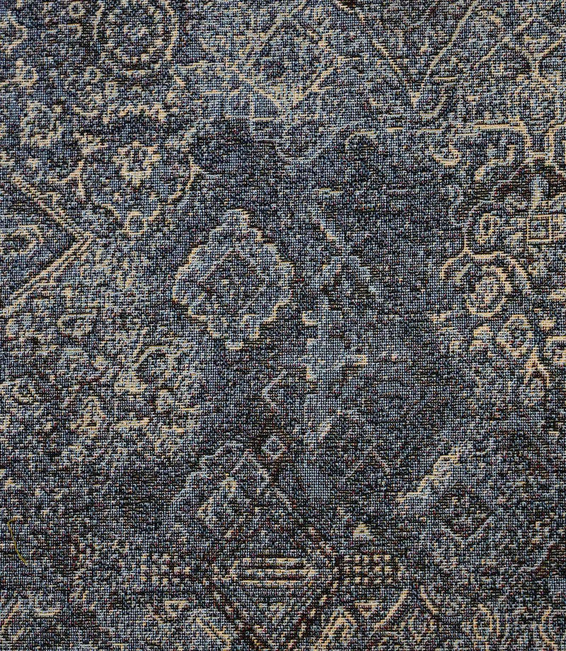 Close-up of blue Keshan tapestry fabric highlighting the intricate woven Persian-inspired pattern and textured finish.