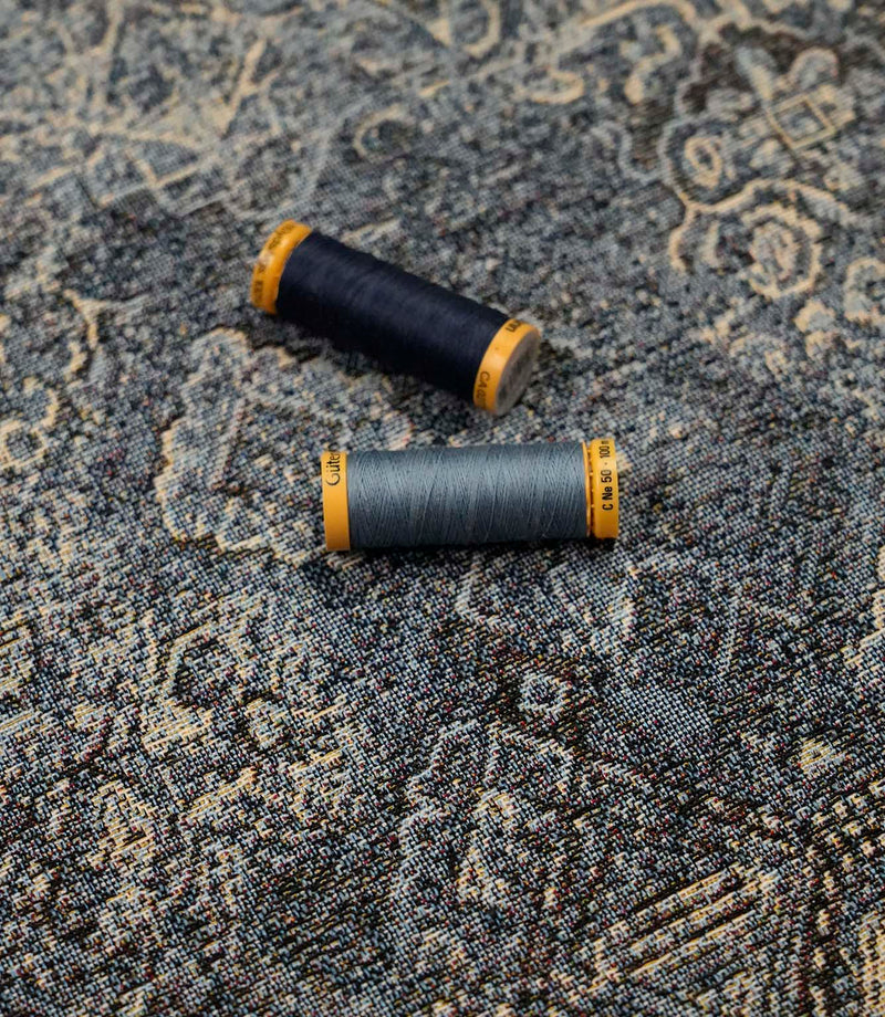 Blue Keshan tapestry fabric with coordinating blue sewing threads, suitable for upholstery, cushions and soft furnishing projects.