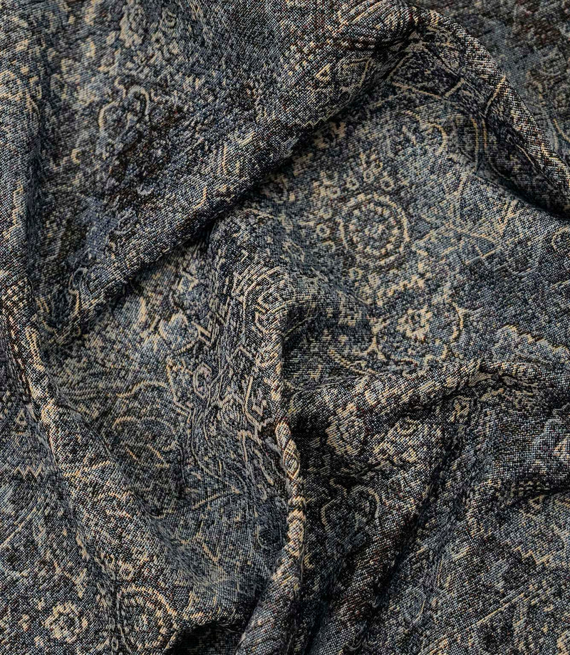 Blue Keshan tapestry fabric draped to display its elegant handle, woven texture and vintage Persian-inspired pattern.