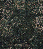 Close-up of green Keshan tapestry upholstery fabric featuring an intricate distressed Persian-inspired woven pattern.
