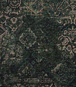 Close-up of green Keshan tapestry upholstery fabric featuring an intricate distressed Persian-inspired woven pattern.